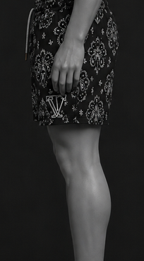 Man wearing black swim shorts with white patterns on a black background