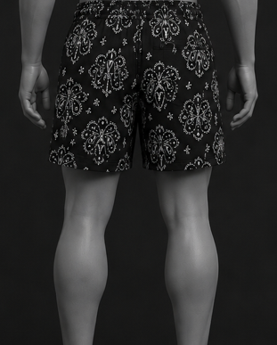 Mannequin wearing black patterned shorts on a black background