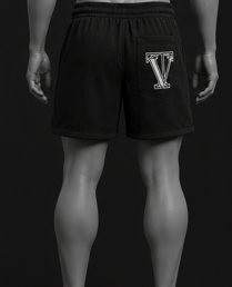Man wearing black shorts with a logo on a black background